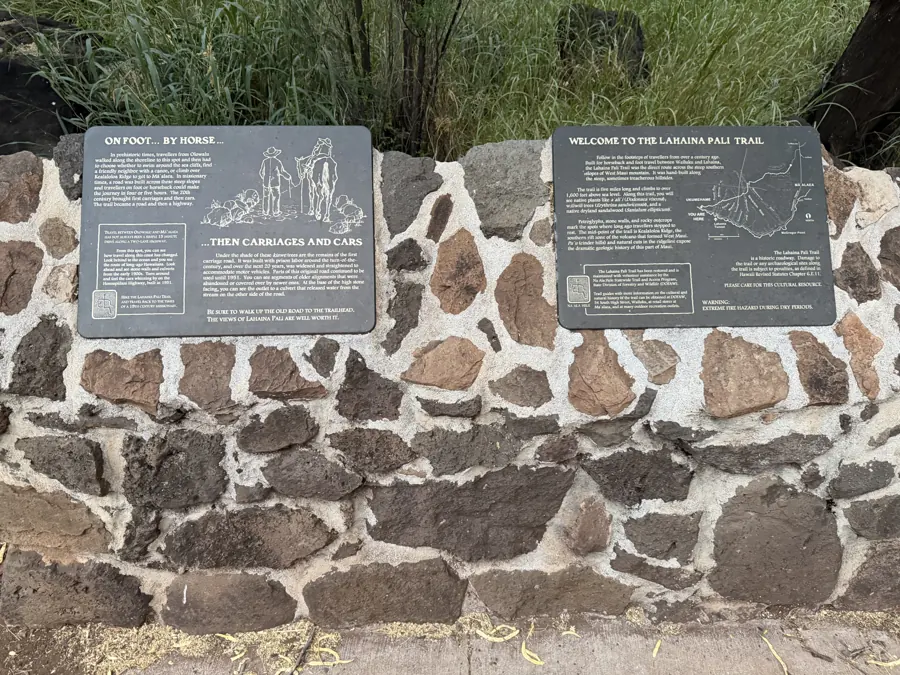 Historical plaques at the Ukumehame (West) trailhead, with a trail map and the road's carriage-era history.