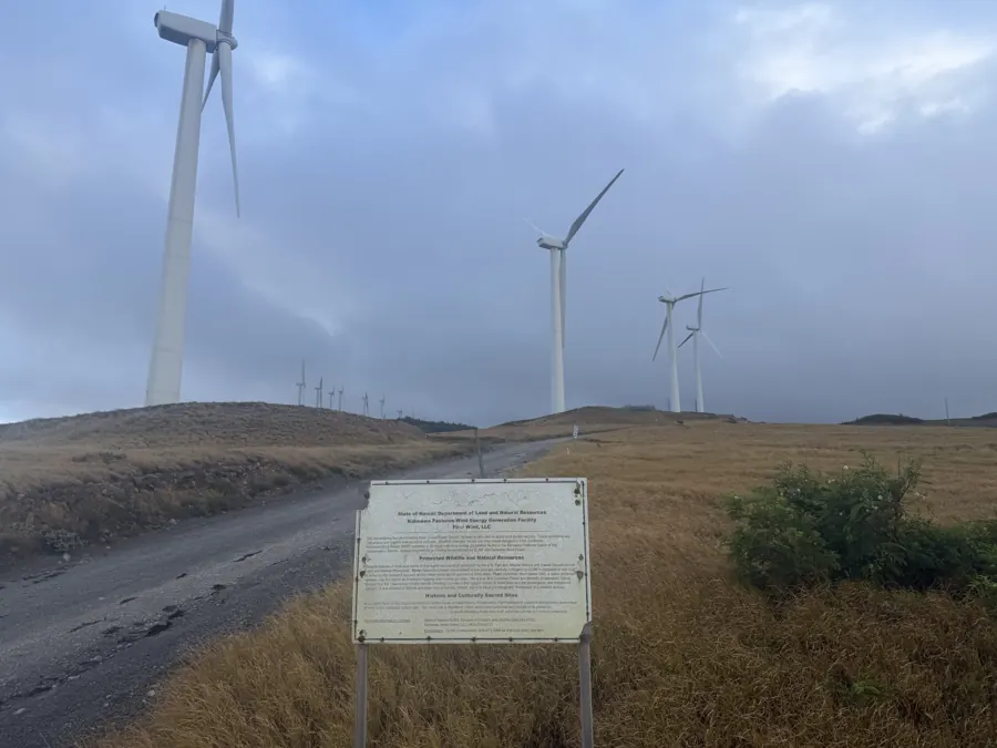 Kaheawa Pastures Wind Farm information sign along the access road, turbines in the mist.